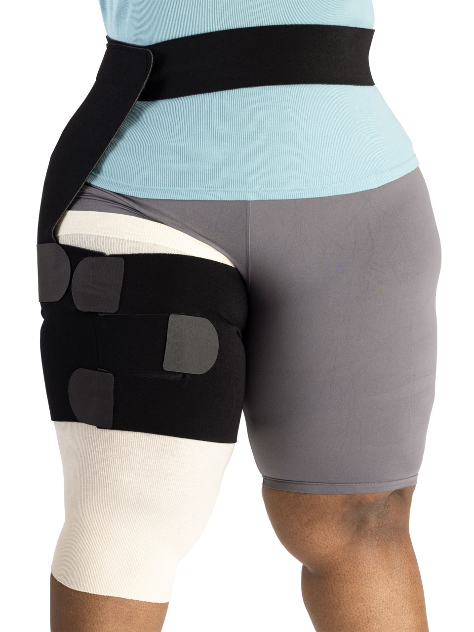 Woman wearing Sigvaris Compreflex Contain Thigh inelastic wrap on right thigh in the color Black